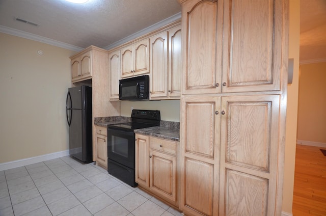 kitchen with light tile patterned floors, crown molding, black appliances, light brown cabinetry, and dark stone counters
