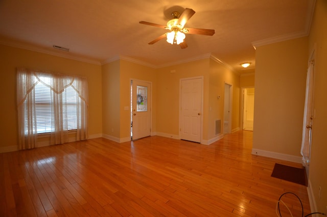 interior space with crown molding, ceiling fan, and light wood-type flooring
