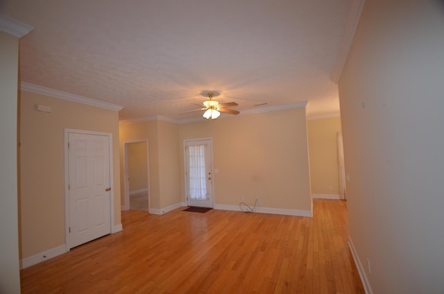 spare room featuring ceiling fan, ornamental molding, and light hardwood / wood-style floors