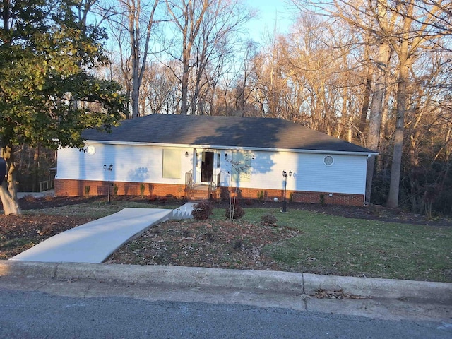 single story home featuring a front lawn