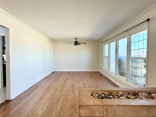 spare room with ceiling fan, ornamental molding, and hardwood / wood-style floors