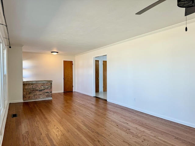 spare room featuring hardwood / wood-style floors, ornamental molding, and ceiling fan