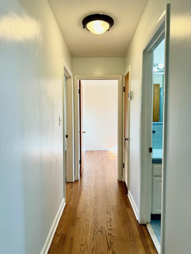 hall with wood-type flooring