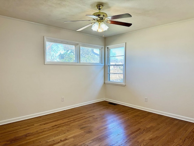 empty room featuring hardwood / wood-style floors, crown molding, and ceiling fan