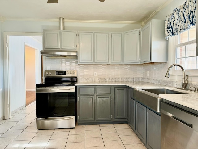 kitchen with gray cabinets, sink, decorative backsplash, ornamental molding, and stainless steel appliances