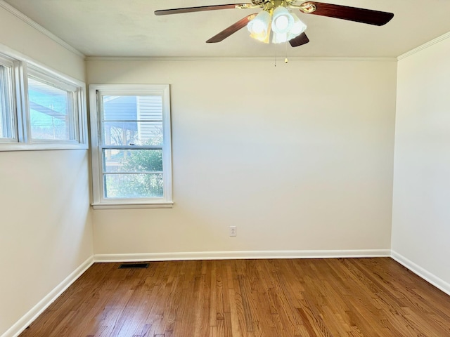 spare room featuring crown molding and hardwood / wood-style floors