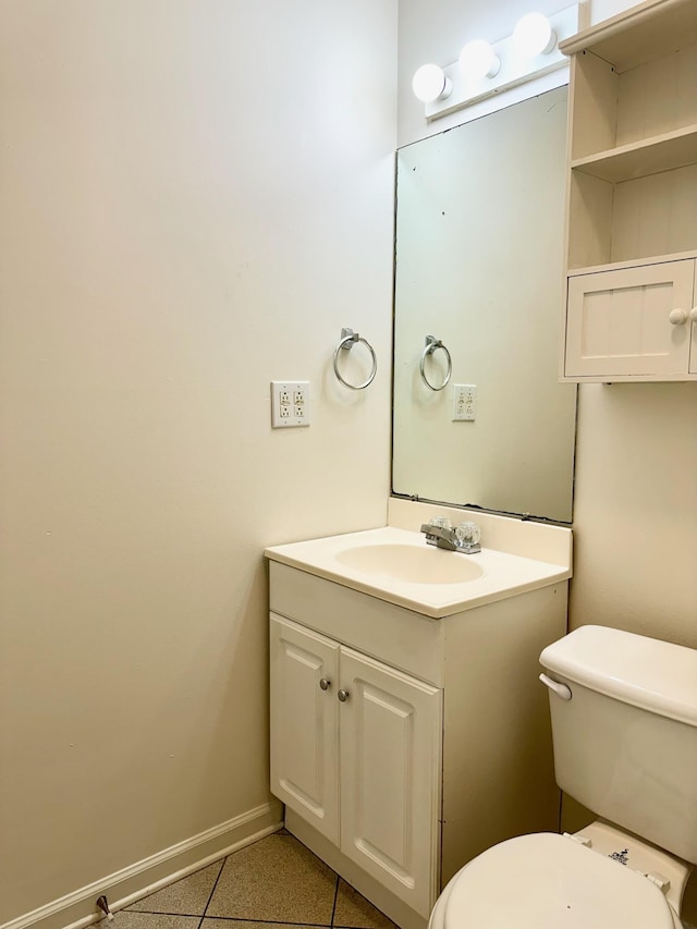 bathroom with tile patterned flooring, vanity, and toilet