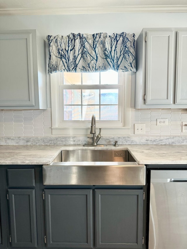 kitchen featuring sink, decorative backsplash, ornamental molding, and stainless steel dishwasher