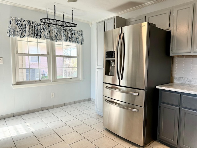 kitchen with gray cabinets, tasteful backsplash, and stainless steel fridge with ice dispenser