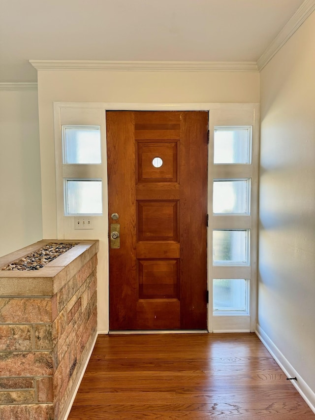 foyer with hardwood / wood-style flooring and ornamental molding