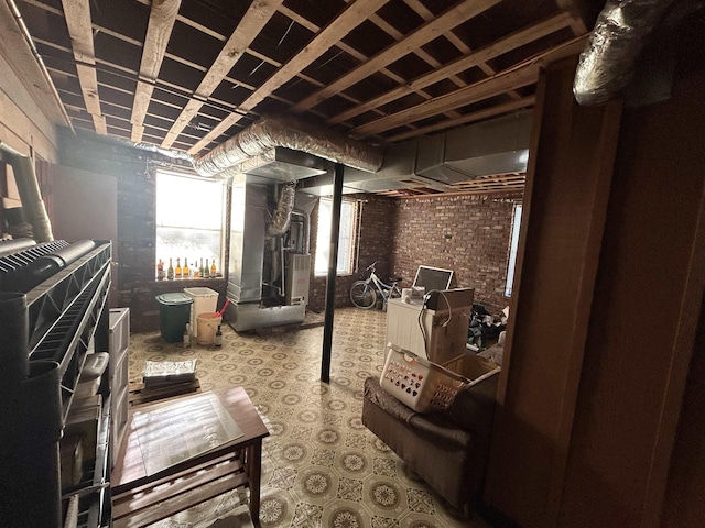 basement with heating unit and brick wall