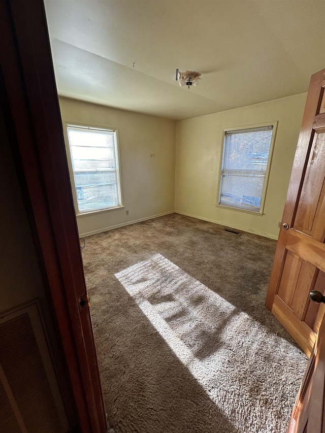 unfurnished room featuring carpet