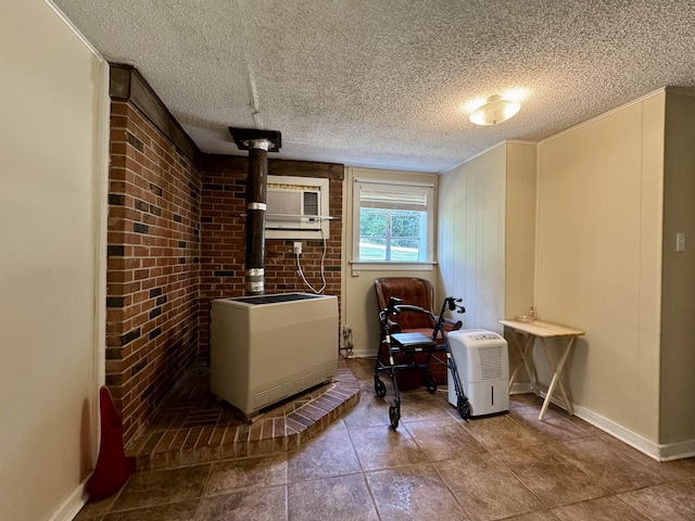  - tiled dining area with a wood stove, a textured ceiling, a wall mounted AC, and baseboards