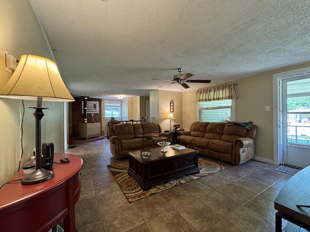  - living area with a textured ceiling, ceiling fan, and baseboards