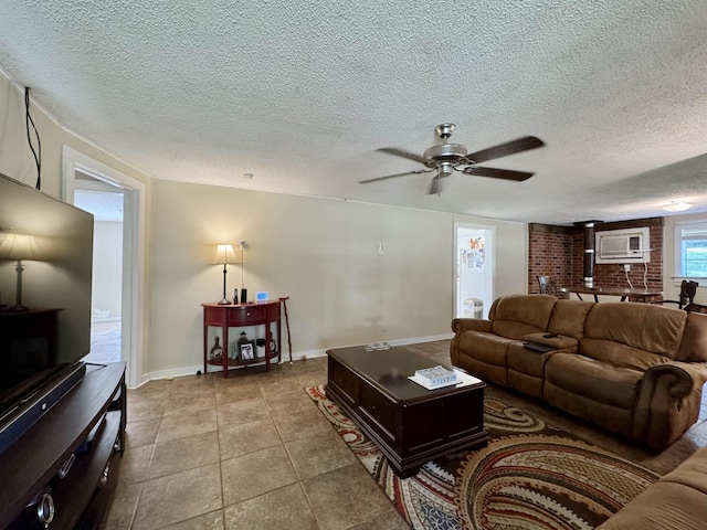  - living area with ceiling fan, a textured ceiling, tile patterned flooring, and baseboards