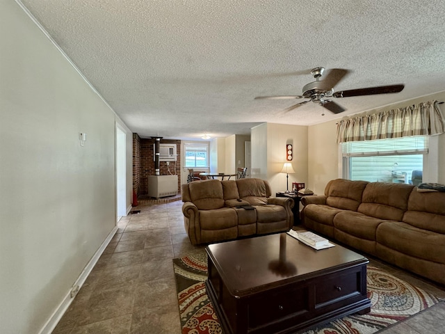 - living room with baseboards, a wood stove, a textured ceiling, and ceiling fan
