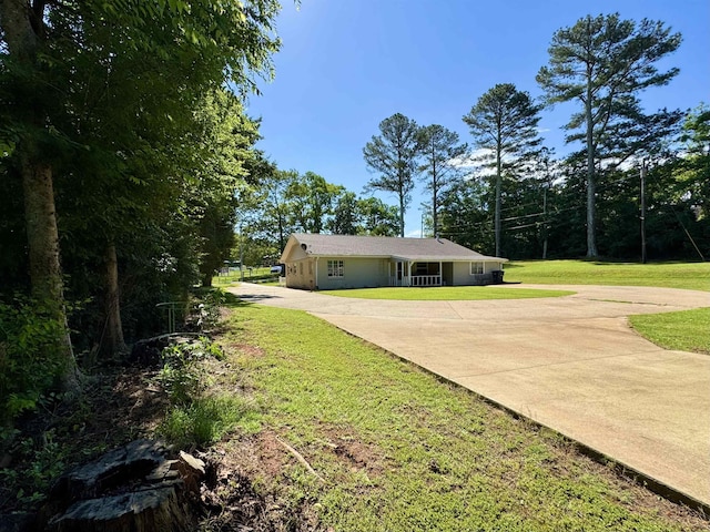  - view of green lawn with concrete driveway
