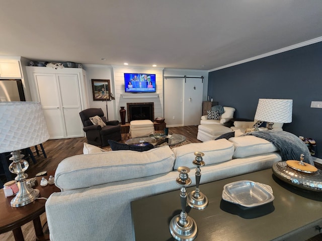 living room featuring dark wood finished floors, crown molding, a brick fireplace, and recessed lighting