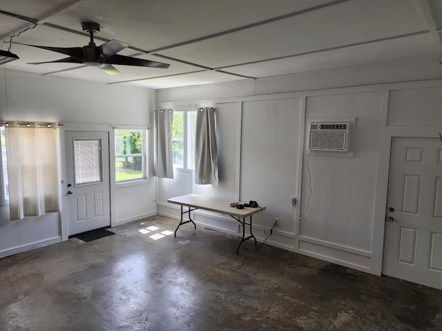 entryway with ceiling fan, an AC wall unit, and concrete flooring
