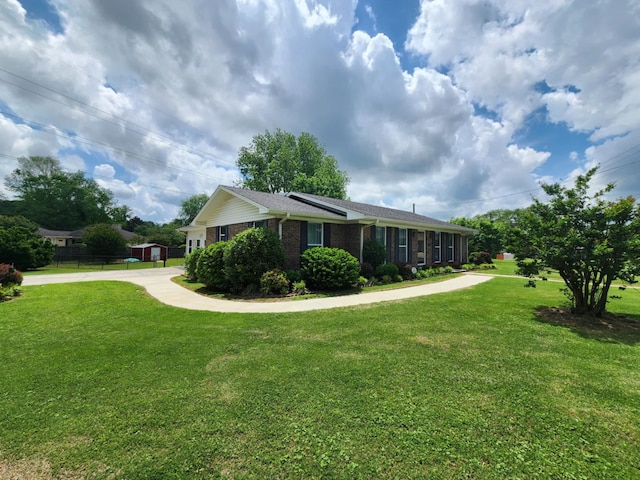 view of side of home with brick siding and a lawn