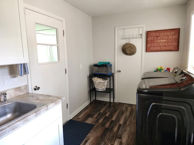 laundry area featuring cabinet space, separate washer and dryer, dark wood-style flooring, and baseboards