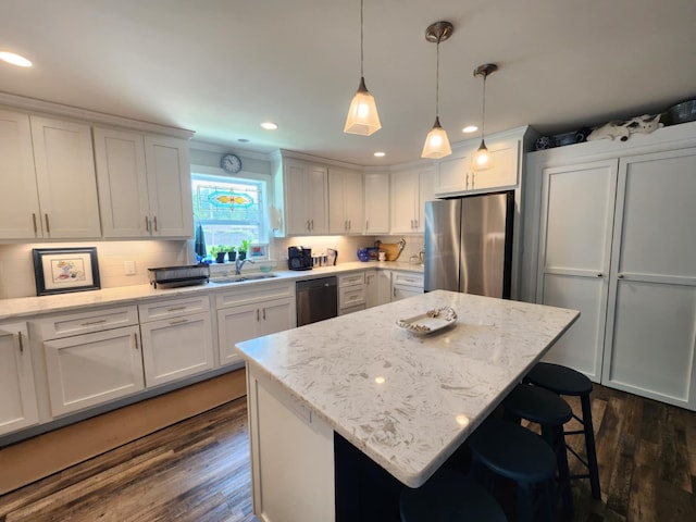 kitchen with freestanding refrigerator, dishwashing machine, a sink, dark wood-style floors, and white cabinets