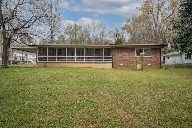 back of property featuring a sunroom, fence, and a yard
