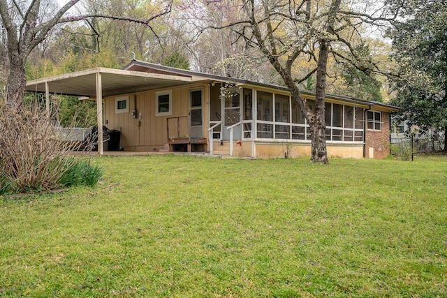 view of front facade featuring a sunroom, a front lawn, and board and batten siding