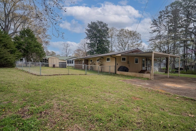 exterior space with driveway, fence, a front yard, and a carport