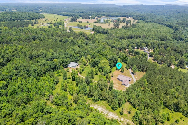 birds eye view of property with a forest view