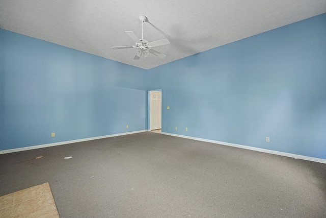 carpeted empty room with ceiling fan, baseboards, and a textured ceiling