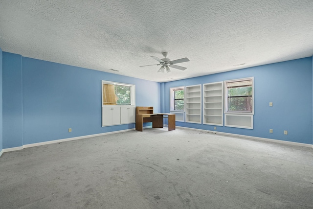 interior space with ceiling fan, a textured ceiling, and baseboards