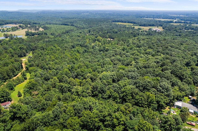 birds eye view of property with a wooded view