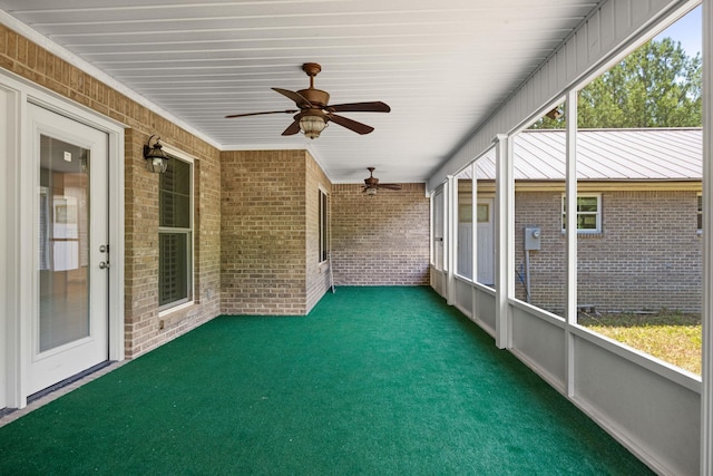 unfurnished sunroom with a healthy amount of sunlight and a ceiling fan