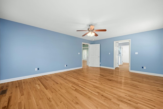 interior space featuring baseboards, ceiling fan, and light wood finished floors