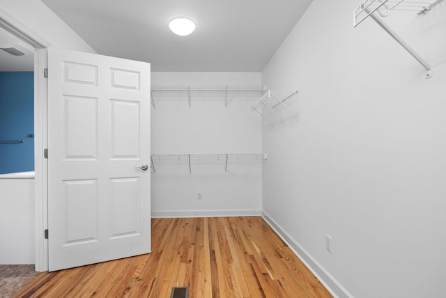 spacious closet featuring light wood-type flooring and visible vents