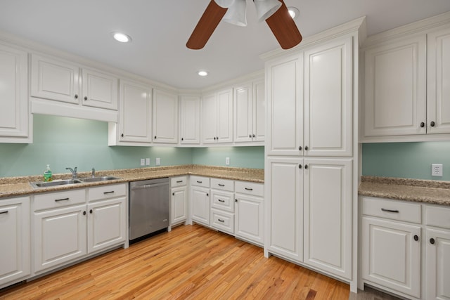 kitchen featuring recessed lighting, light wood-style floors, white cabinets, a sink, and dishwasher