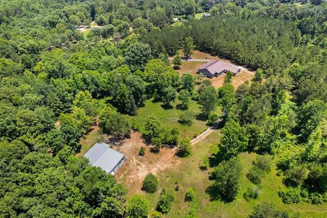 drone / aerial view with a wooded view