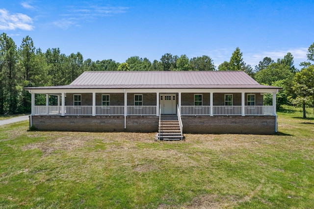 country-style home featuring brick siding, covered porch, crawl space, metal roof, and a front lawn