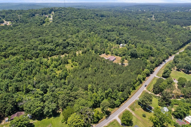 birds eye view of property featuring a forest view