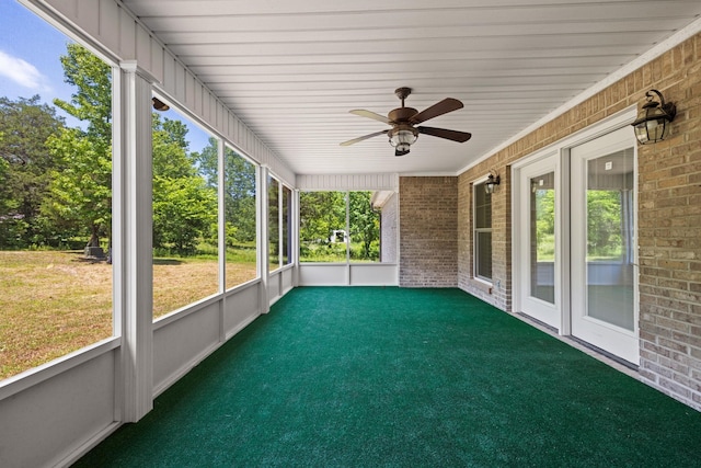 unfurnished sunroom with a ceiling fan