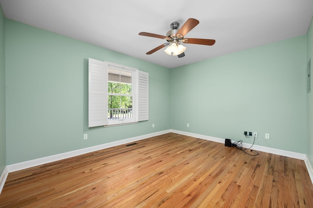 empty room featuring ceiling fan, baseboards, and wood finished floors