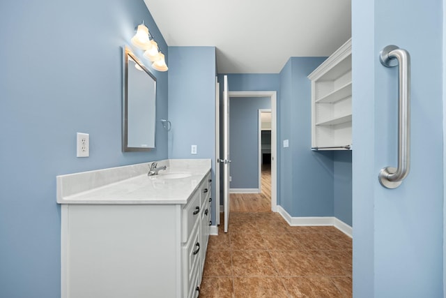 bathroom featuring vanity, baseboards, and tile patterned floors