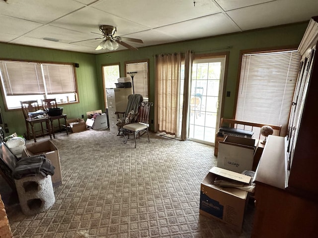  - living area with a ceiling fan and carpet