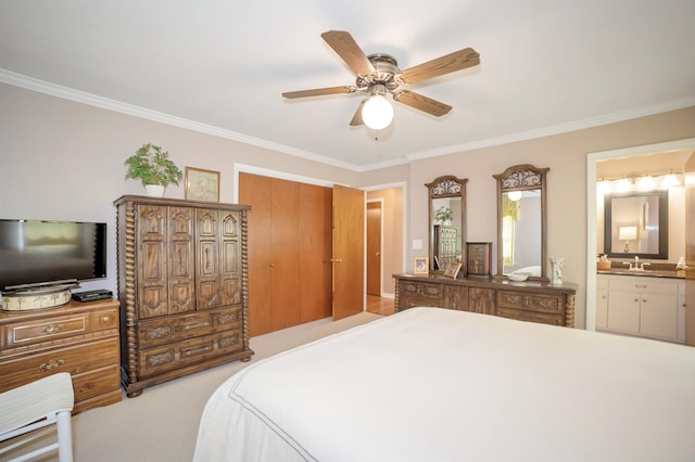 bedroom featuring carpet flooring, a sink, crown molding, and ensuite bathroom