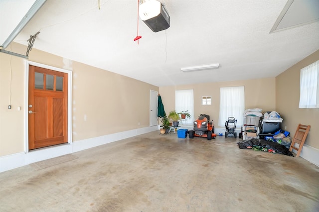 garage with a garage door opener and baseboards