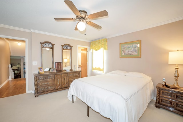 bedroom featuring a ceiling fan, ornamental molding, and light carpet