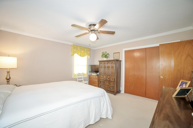 bedroom featuring ornamental molding, a closet, light colored carpet, and ceiling fan