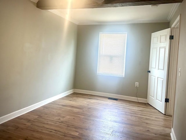  - spare room featuring crown molding, wood finished floors, and a smoke detector