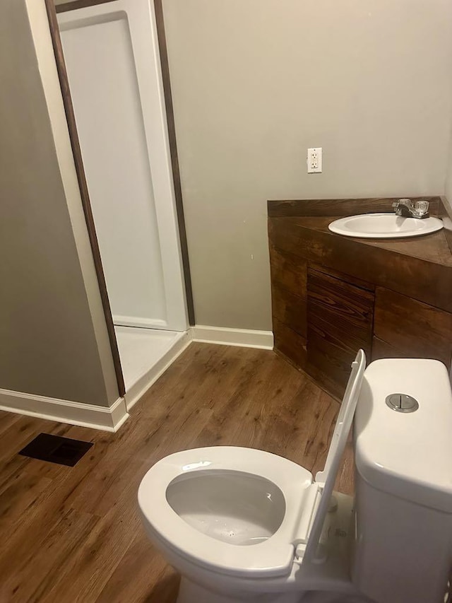  - bathroom featuring wood finished floors and vanity